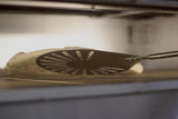 GI METAL GI.I-23F/75 Detail of the head of the peel under a cooking pizza inside an oven - La Pizza Hub